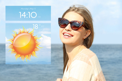 Young woman wearing stylish sunglasses near river and weather forecast widget. Mobile application