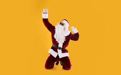 Santa Claus with sunglasses on yellow background