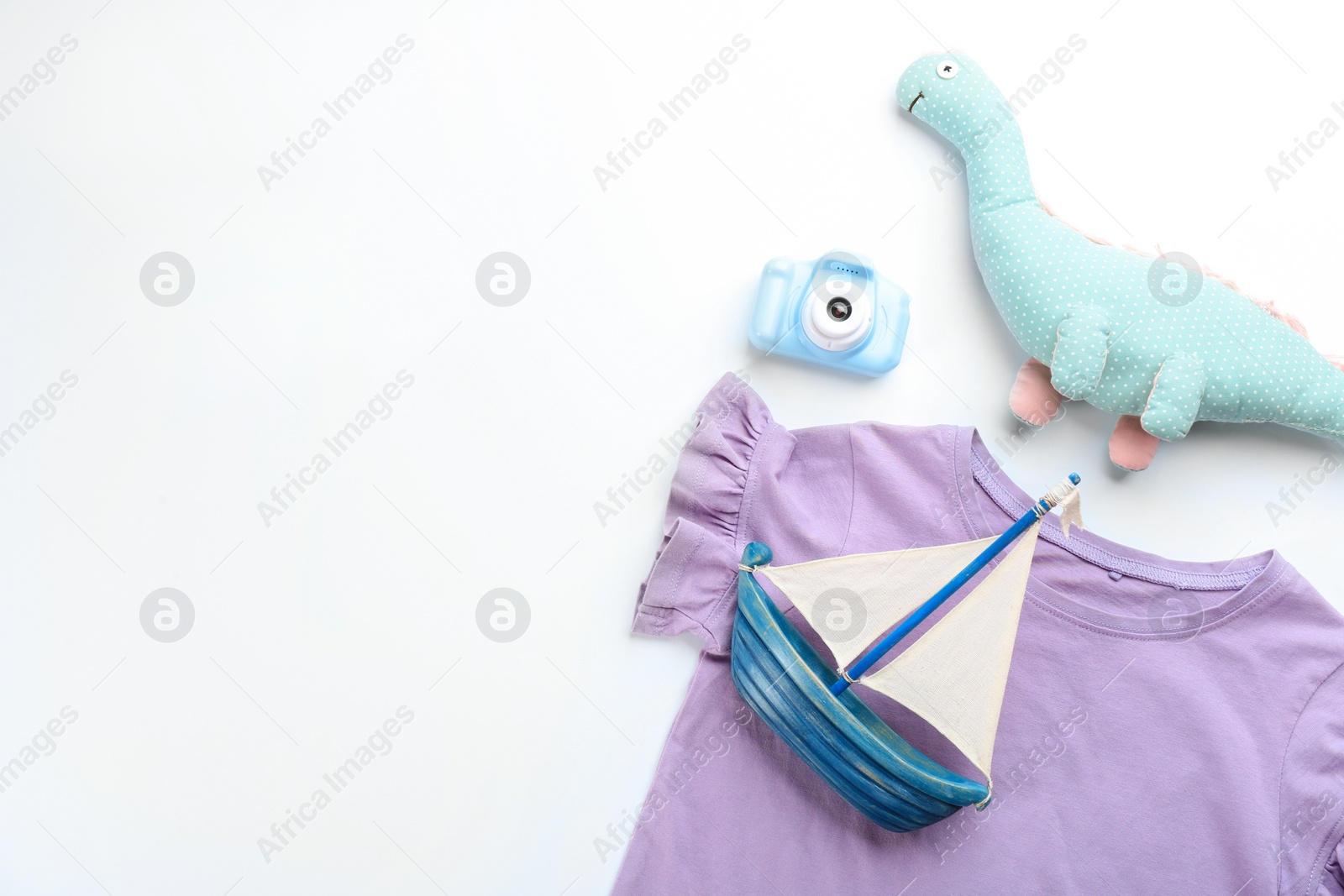 Photo of Flat lay composition with little photographer's toy camera on white background. Space for text