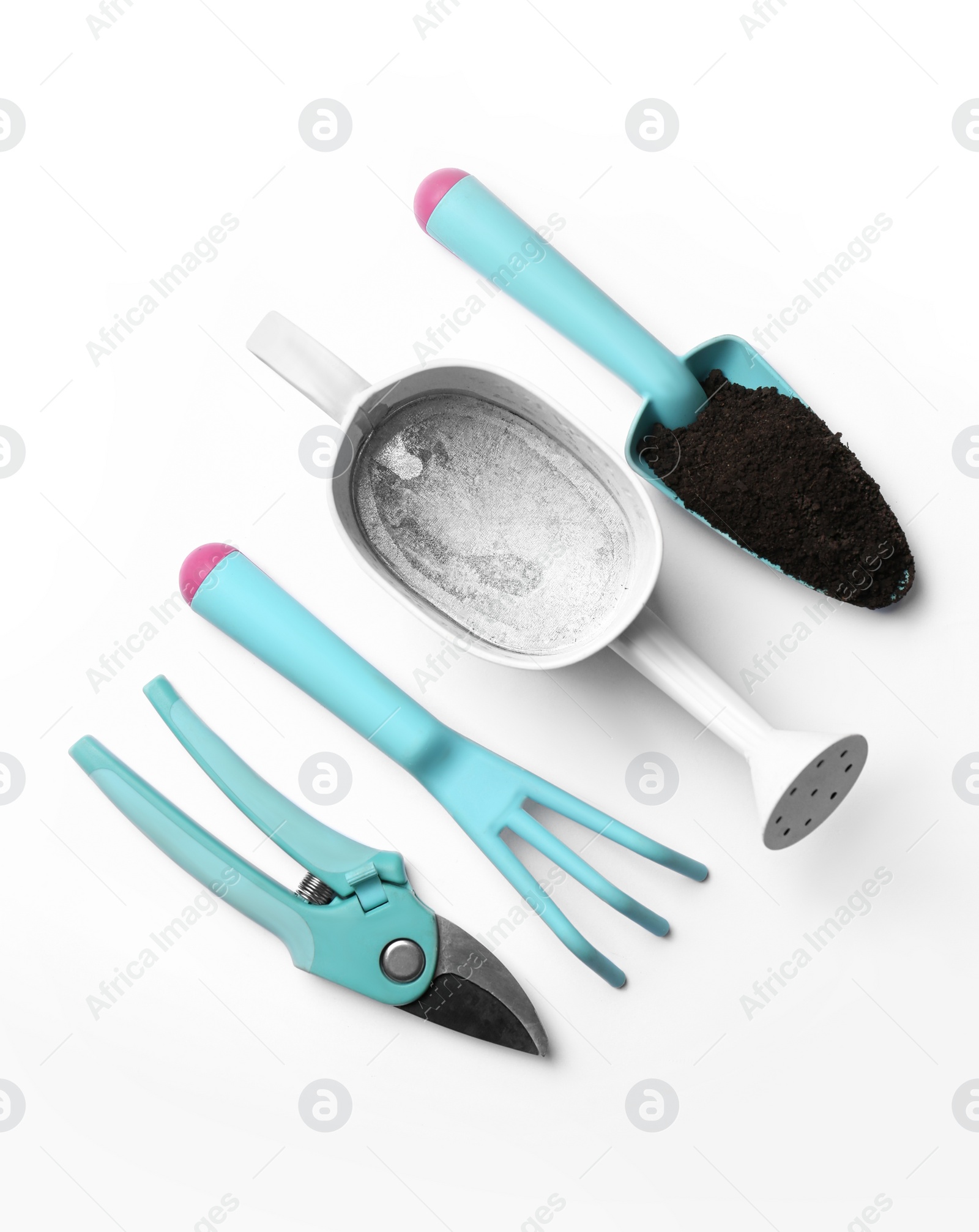 Photo of Watering can and gardening tools on white background, flat lay