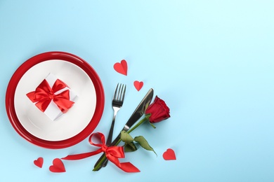 Photo of Beautiful table setting on light blue background, flat lay with space for text. Valentine's Day dinner
