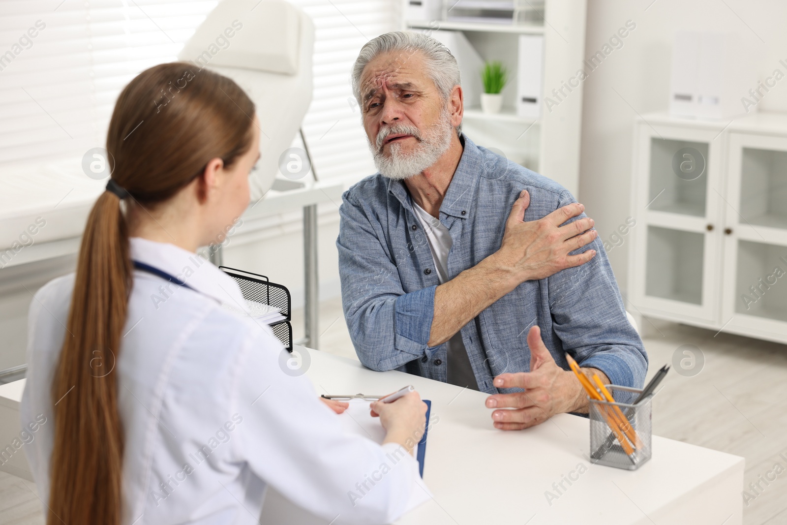 Photo of Arthritis symptoms. Doctor consulting patient with shoulder pain in hospital