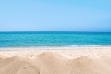 Image of Beautiful sandy beach near sea under blue sky