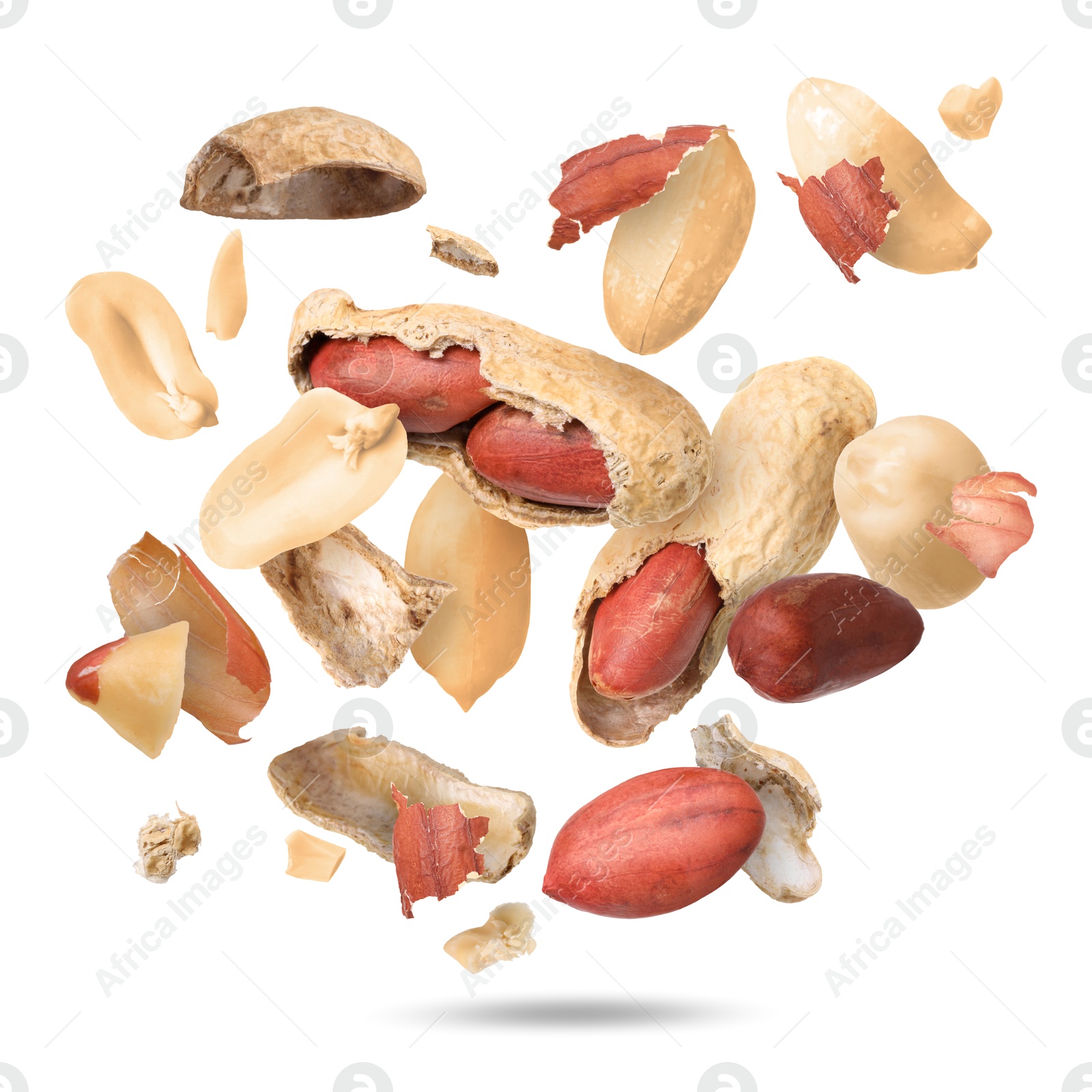 Image of Peanuts and crushed pods in air on white background