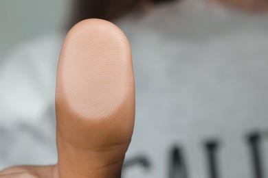 Woman pressing finger to surface, closeup view. Scanning fingerprint