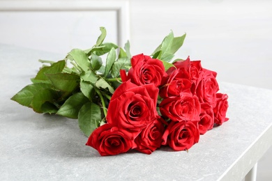 Beautiful red rose flowers on table indoors