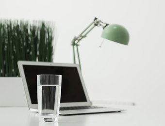 Glass of fresh water on table indoors. Space for text