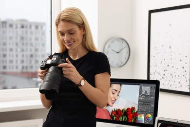 Professional photographer with modern digital camera in office