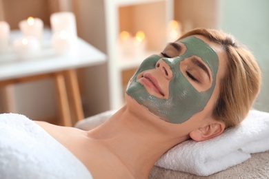 Photo of Beautiful woman with mask on face relaxing in spa salon