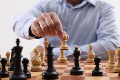 Man playing chess during tournament at chessboard, closeup