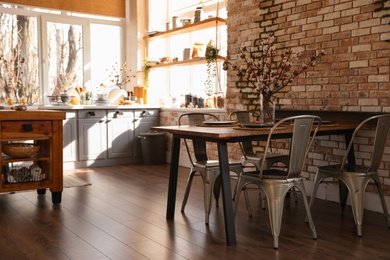 Stylish kitchen interior with dining table and chairs