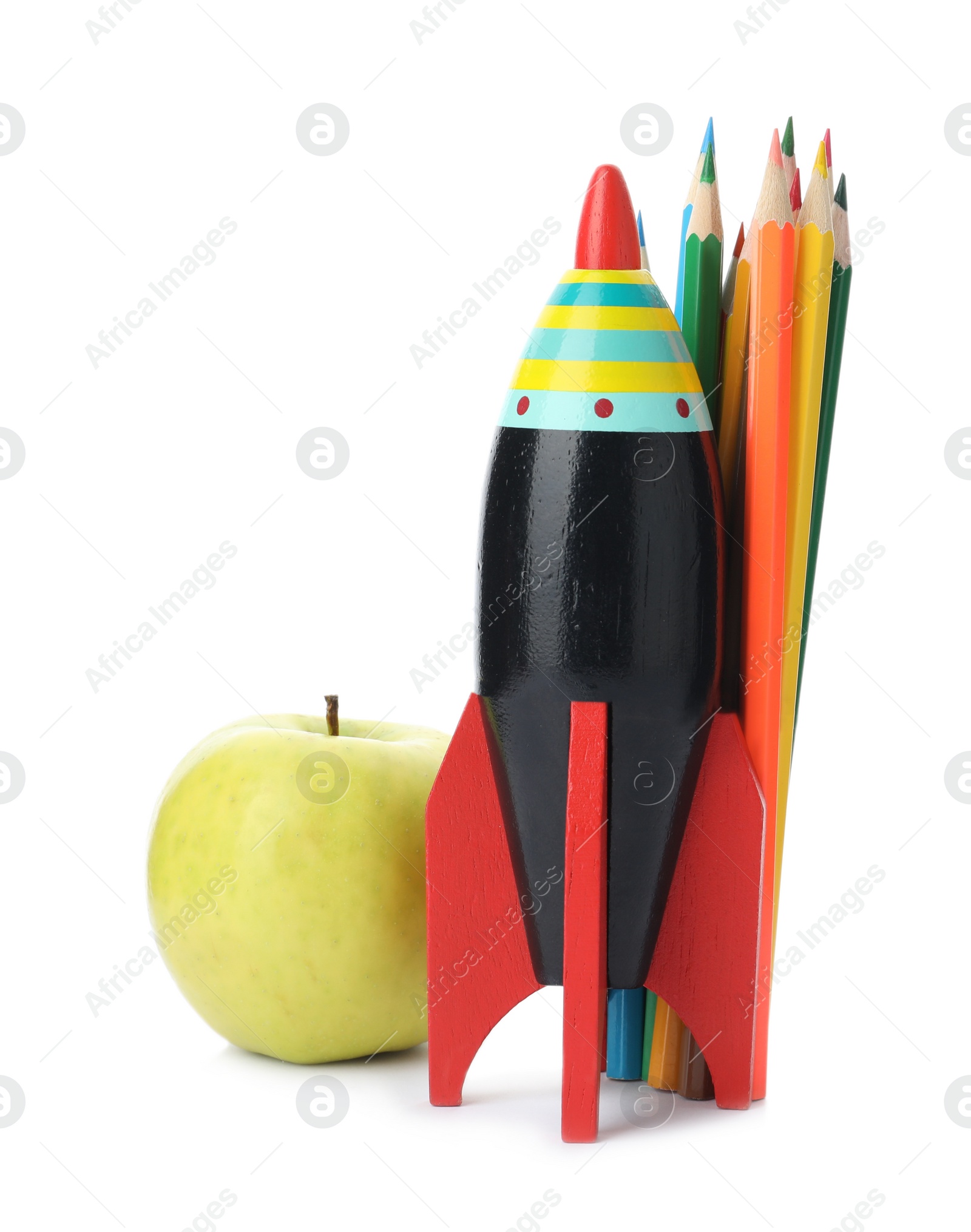 Photo of Bright modern toy rocket, pencils and apple isolated on white. Back to school