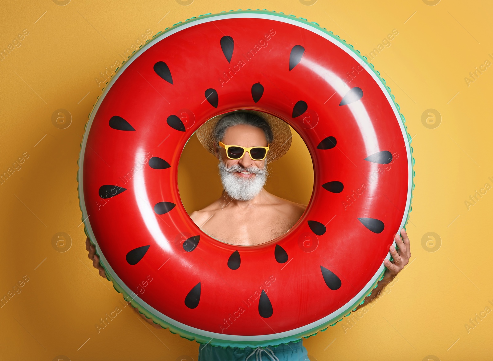 Photo of Shirtless man with inflatable ring on color background