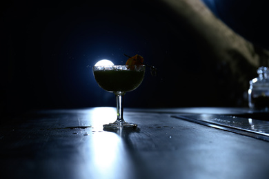 Photo of Glass of fresh alcoholic cocktail on bar counter