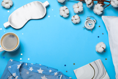Photo of Flat lay composition with sleeping mask on light blue background, space for text. Bedtime accessories