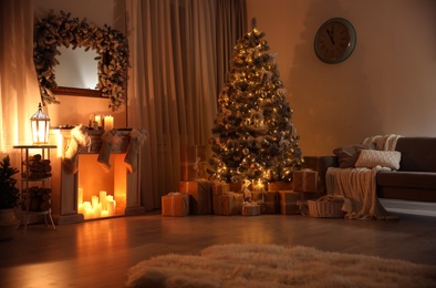 Photo of Stylish interior with decorative fireplace and beautiful Christmas tree in evening