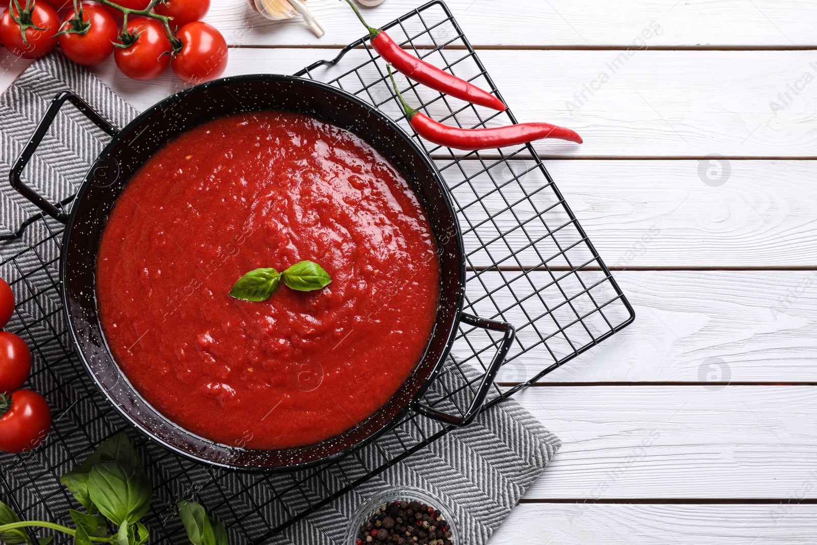 Photo of Delicious tomato sauce on white wooden table, flat lay. Space for text