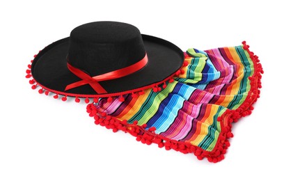 Photo of Mexican sombrero hat and colorful poncho isolated on white
