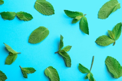 Fresh mint leaves on light blue background, flat lay