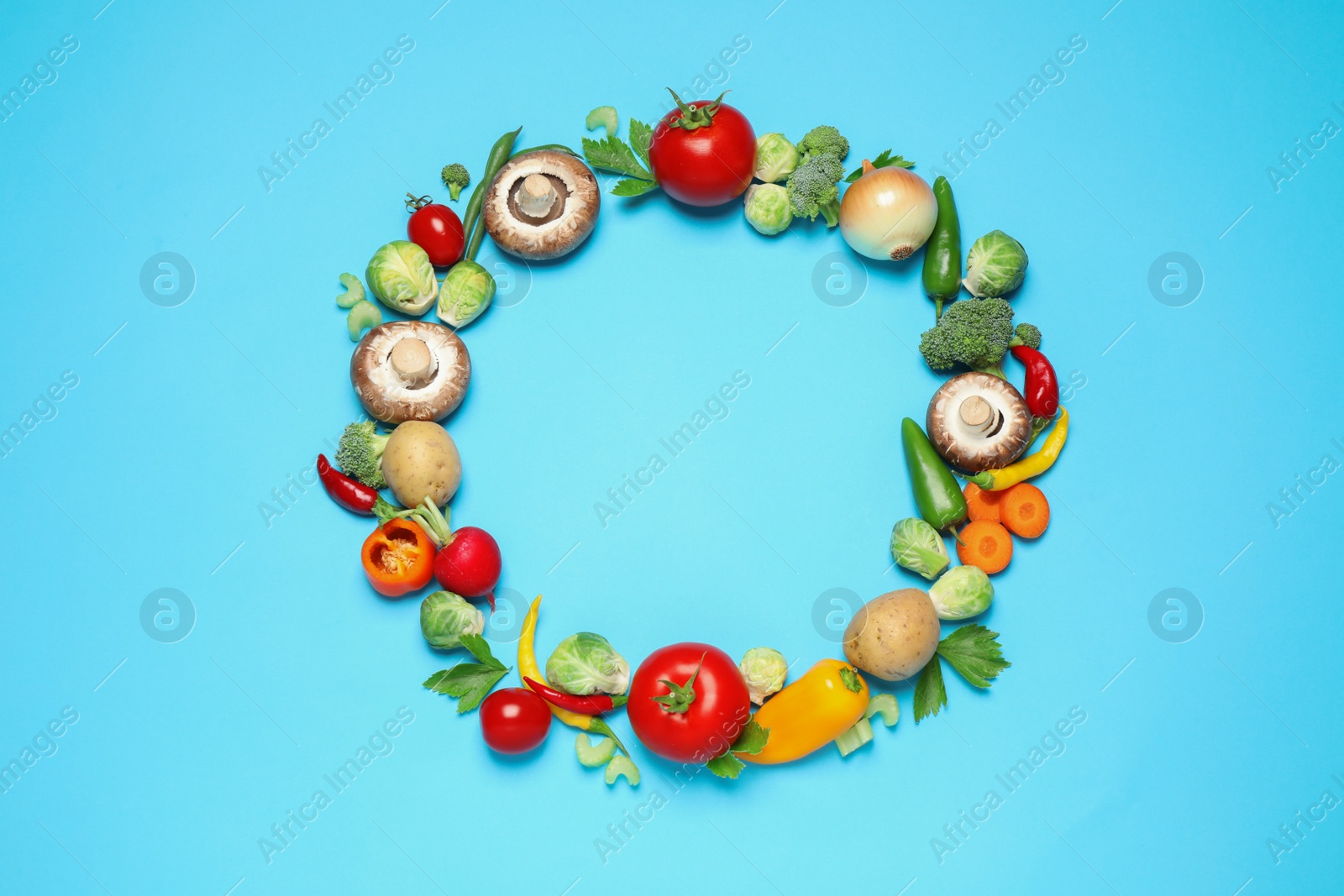 Photo of Frame of different fresh vegetables on light blue background, flat lay. Space for text