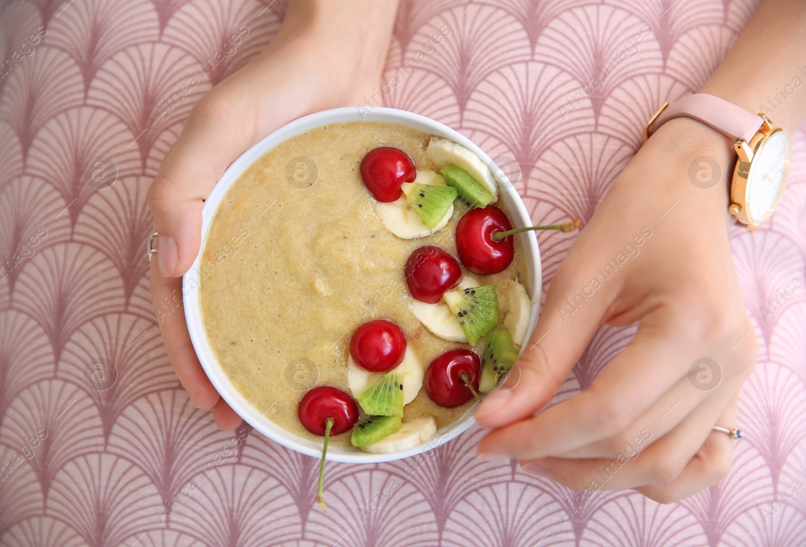 Photo of Young woman with bowl of healthy smoothie, closeup