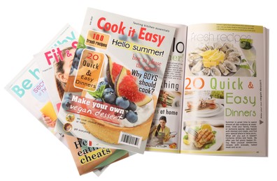 Stack of different magazines on white background, top view