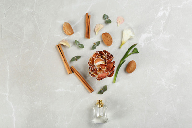 Flat lay composition with bottle of perfume on marble background