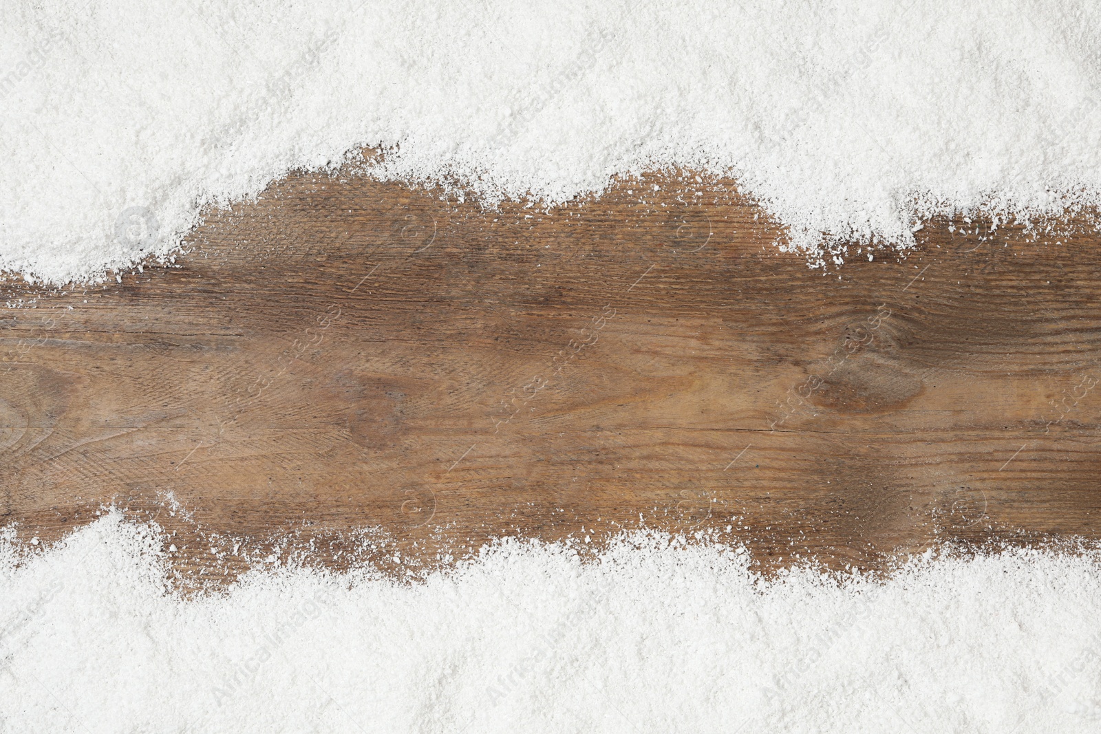 Photo of Artificial snow on wooden background, flat lay with space for text. Christmas decor