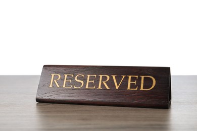 Photo of Elegant wooden sign Reserved on table against white background