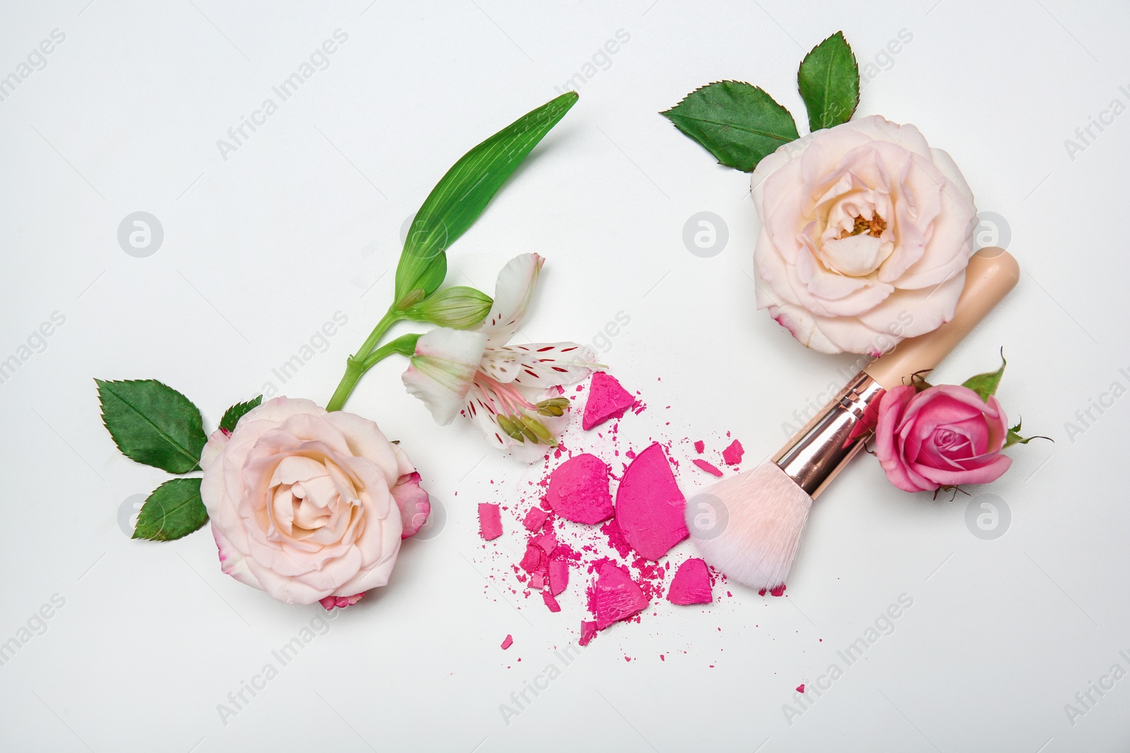 Photo of Flat lay composition with makeup brush and flowers on white background