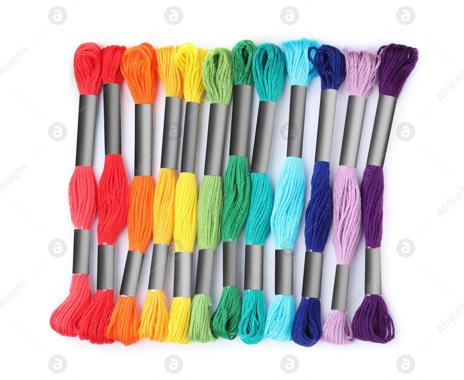 Photo of Set of colorful embroidery threads on white background, top view