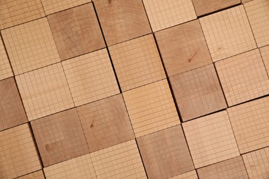Photo of Set of wooden cubes as background, top view. Montessori toy