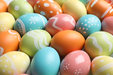 Photo of Many beautiful painted Easter eggs as background, closeup