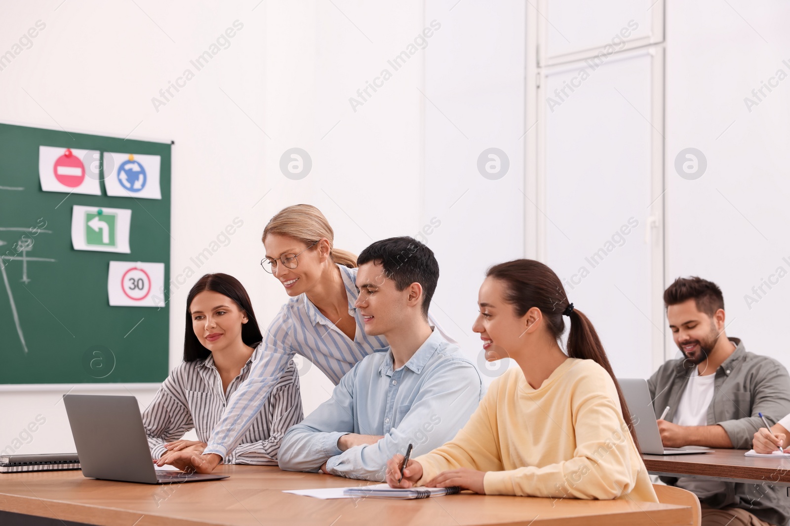 Photo of Teacher giving lesson to audience in driving school