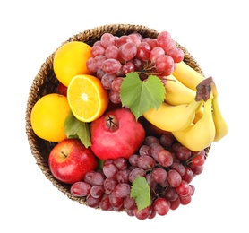 Wicker basket with different fruits on white background, top view