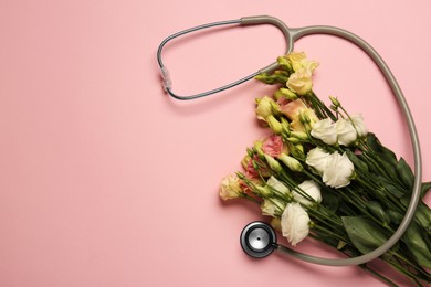 Photo of Stethoscope and flowers on pink background, flat lay with space for text. Happy Doctor's Day