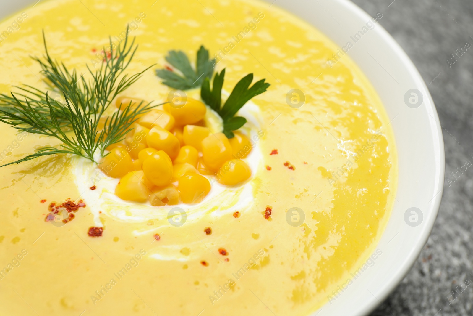 Photo of Delicious creamy corn soup in bowl, closeup