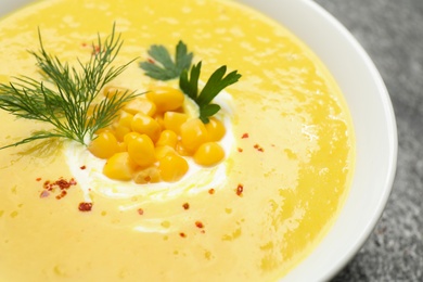 Photo of Delicious creamy corn soup in bowl, closeup