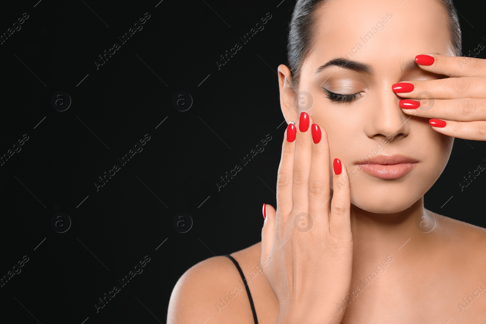 Photo of Beautiful young woman with bright manicure on black background, space for text. Nail polish trends