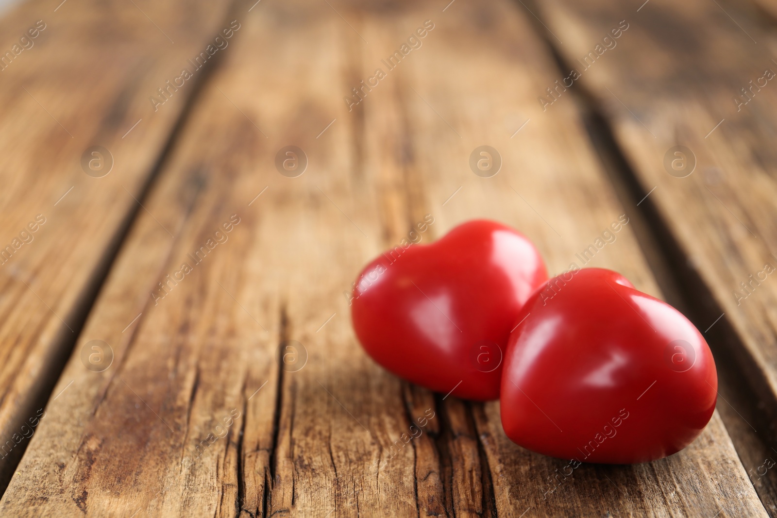 Photo of Red hearts on wooden table, space for text. St. Valentine's day