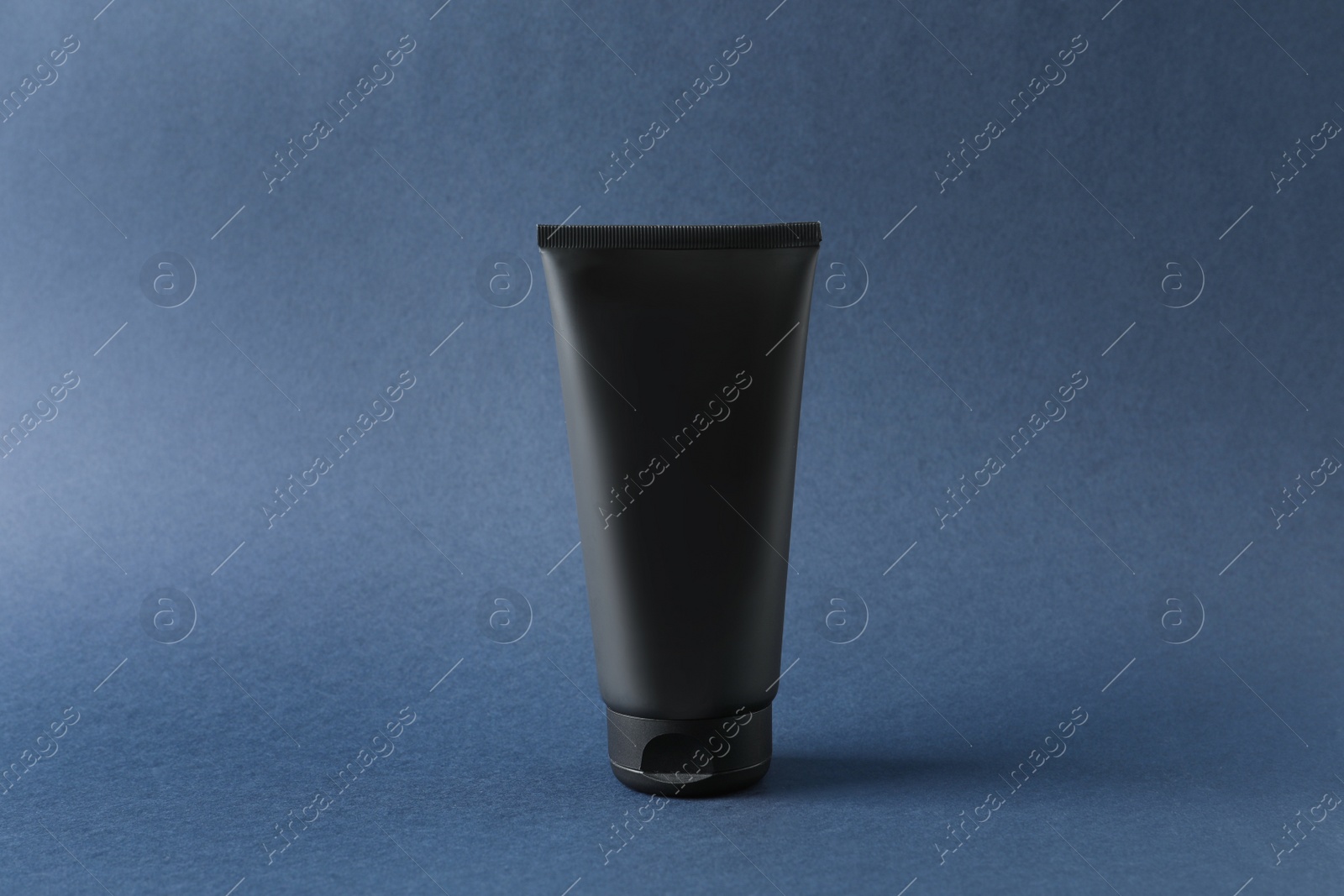 Photo of Tube of men's facial cream on grey background