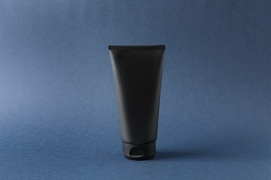 Photo of Tube of men's facial cream on grey background