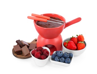 Photo of Fondue pot with melted chocolate, fresh berries and forks isolated on white