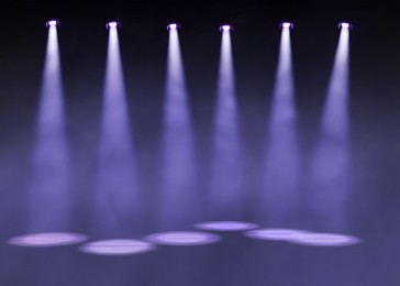 Image of Bright spotlights in dark room. Performance equipment