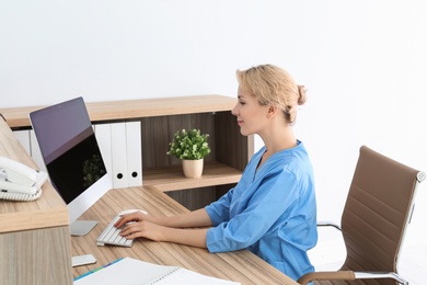 Photo of Female medical assistant at workplace in clinic. Health care service