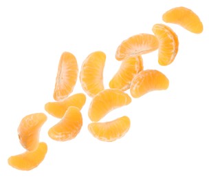 Image of Pieces of tasty tangerines falling on white background