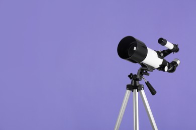 Tripod with modern telescope on light purple background, space for text