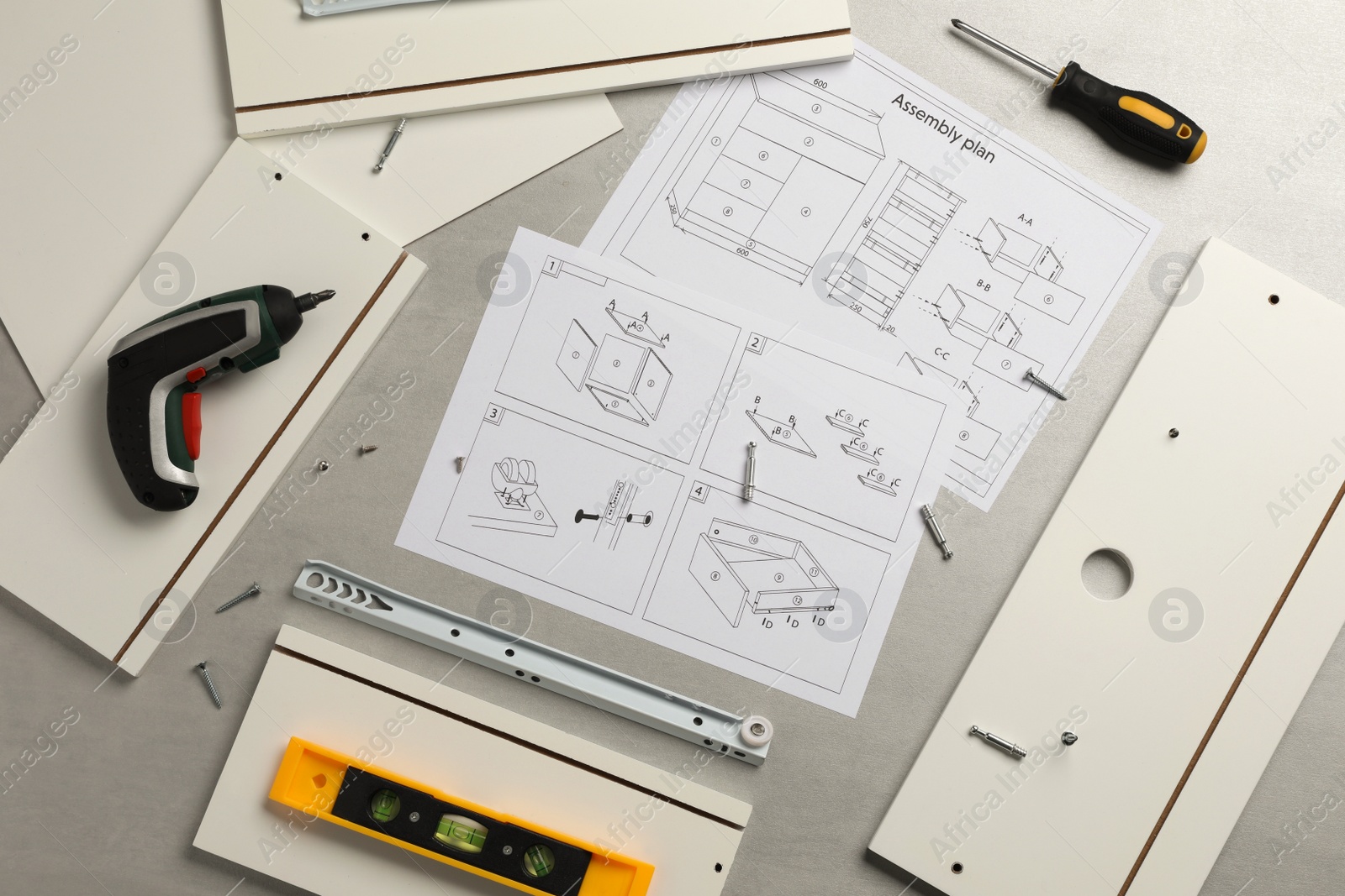 Photo of Flat lay composition with furniture parts and tools for self-assembly on grey background