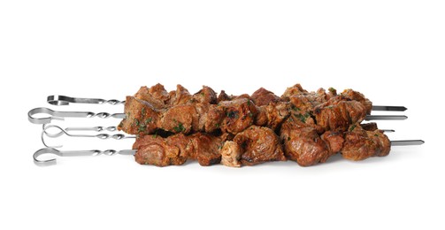 Metal skewers with delicious meat on white background