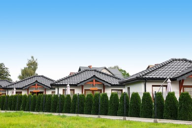 Photo of Beautiful view of white houses behind fence